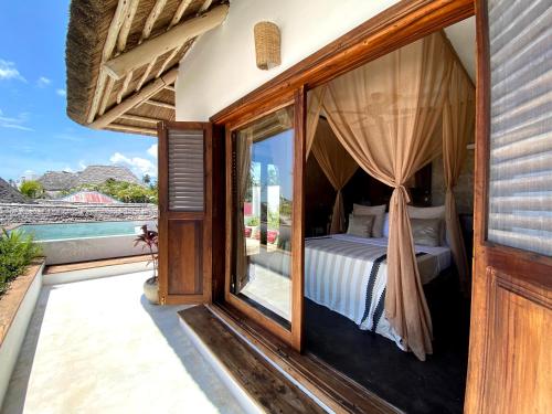 Postel nebo postele na pokoji v ubytování Joya' Beach Suites & Villa