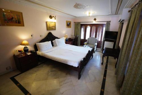 
A bed or beds in a room at The Laxmi Niwas Palace
