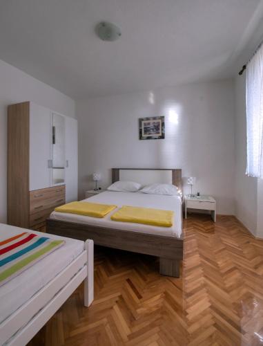 a bedroom with a large bed and wooden floors at Pipe in Metajna