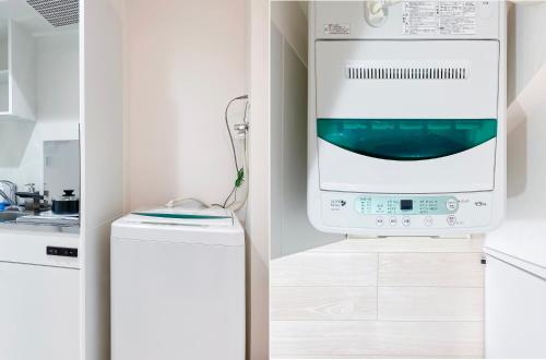 a kitchen with a dishwasher and a washing machine at japan house shinkoiwa in Tokyo