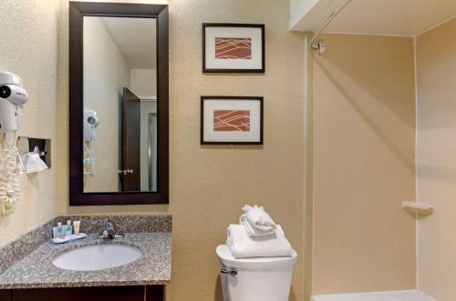 a bathroom with a toilet and a sink and a mirror at Comfort Inn Bluefield in Bluefield