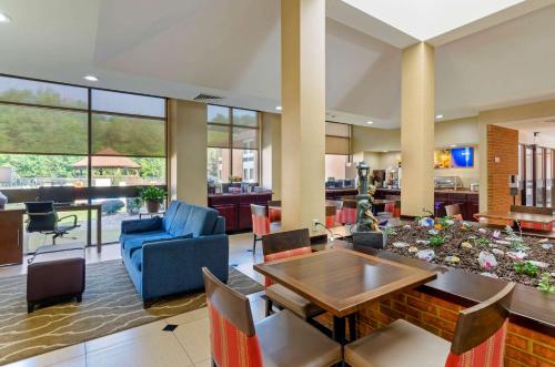 a living room with a blue couch and a table at Comfort Inn in Bluefield