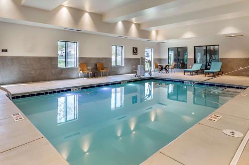 a swimming pool with blue water in a building at Comfort Suites Grandview - Kansas City in Grandview
