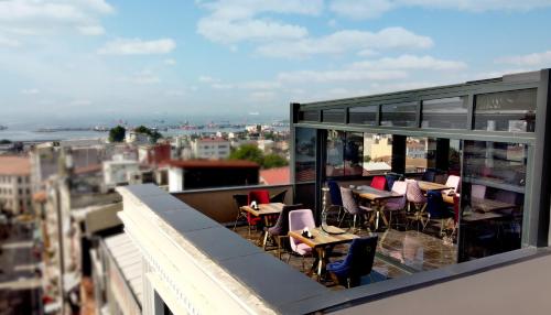 a balcony with tables and chairs on a building at The Grand Tower Hotel in Istanbul