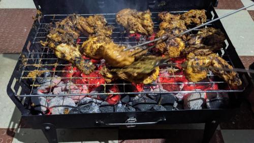 una parrilla con muchos tipos diferentes de comida en ella en Chamayam Holiday Villa, en Meenangadi