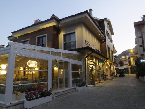 a building on a street with a store at Resa Hotel Göcek in Göcek