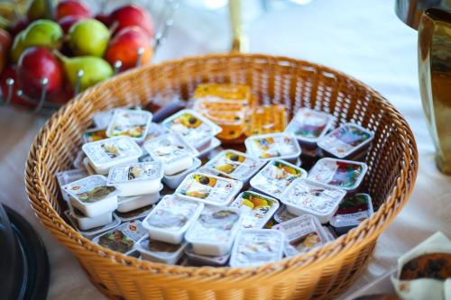 a basket filled with different types of food and apples at Aliko Hotel in Vlorë