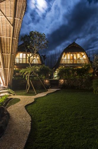 a house with a pathway leading to a building at Sandat Glamping Tents in Ubud