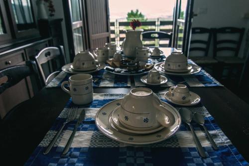 a table with plates and cups on a table at Campo Felice Experience in Rocca di Cambio