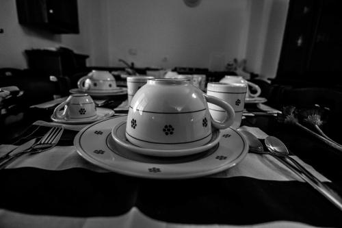 a black and white photo of a tea pot on a table at Campo Felice Experience in Rocca di Cambio
