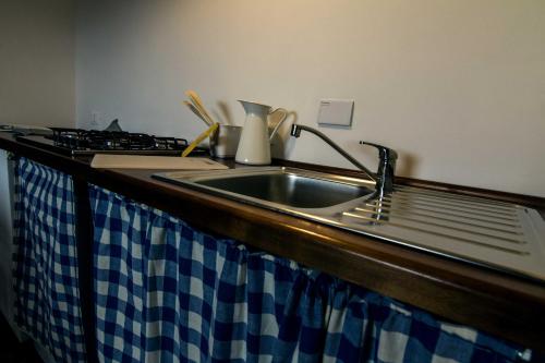 a kitchen counter with a sink and a stove at Campo Felice Experience in Rocca di Cambio
