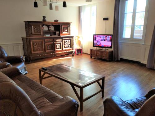 a living room with a couch and a coffee table at Gite de l'Arbalète in Autun