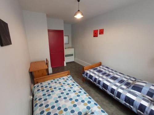 1 Schlafzimmer mit 2 Betten und einem roten Schrank in der Unterkunft Gite de l'Arbalète in Autun