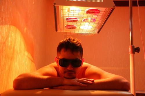 a man in sunglasses sitting in a tub with a basketball hoop at HUMSON BULOQ SANATORIUM in Khumson