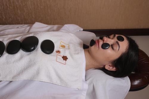 a woman laying on a bed with black face paint at HUMSON BULOQ SANATORIUM in Khumson