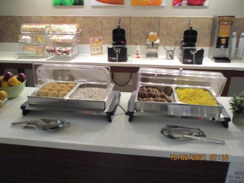 a buffet line with different types of food on a counter at Quality Inn & Suites Kissimmee by The Lake in Orlando