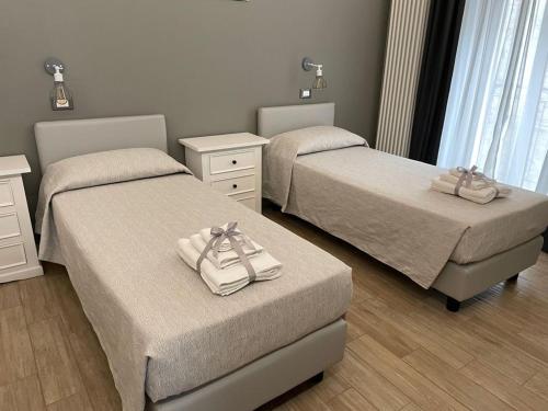 a bedroom with two beds with towels on them at Nina e il mare in Campomarino