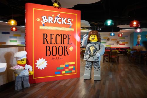two lego people standing next to a sign that reads bricks rescue book at LEGOLAND New York Resort in Goshen