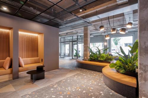 an office lobby with benches and plants at Citybox Antwerp in Antwerp