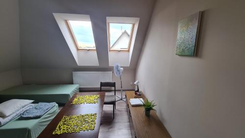 a small room with two beds and a window at W20 Hostel in Golędzinów