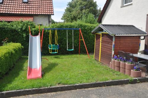 a yard with a playground with a swing at Gasthof Liederhalle in Aalen