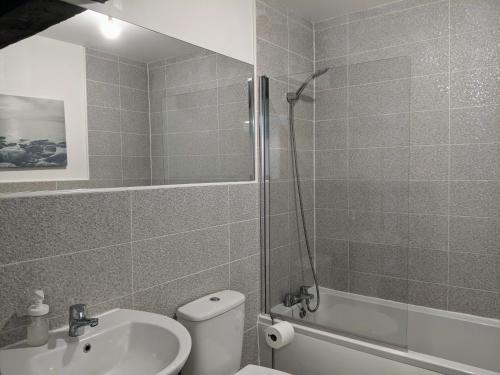 a bathroom with a shower and a toilet and a sink at Riverside Apartment York in York