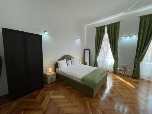 a bedroom with a bed and a wooden floor at 1501 Wergass 18 in Sibiu