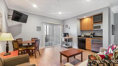 a living room with a table and a kitchen at The Cliffside Resort Condominiums in Greenport