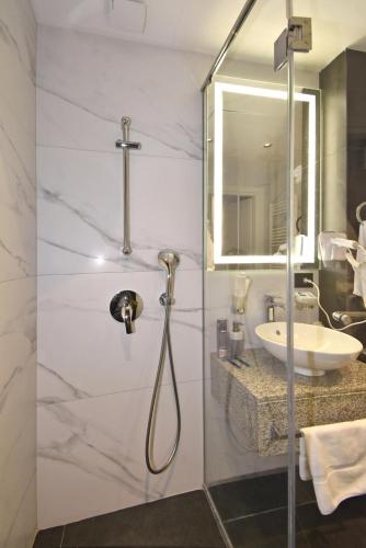 a bathroom with a shower and a sink at Avenue ApartHotel in Yerevan