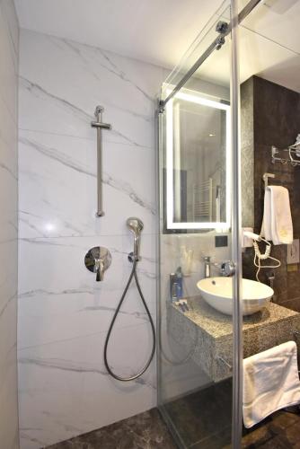 a bathroom with a shower and a sink at Avenue ApartHotel in Yerevan