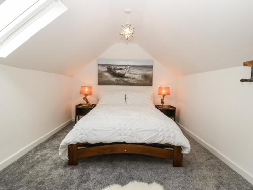 a bedroom with a bed and two night stands at Littlemoor Cottage in Cheddar