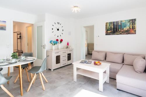 a living room with a couch and a table at Apartment "Haffblick" - Haffresidenz in Zirchow