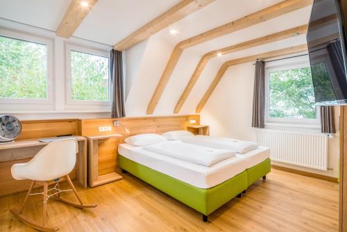 ツィルンドルフにあるHatzels Häuschenのベッドルーム1室(ベッド1台、デスク、窓付)