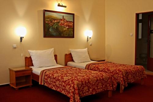 una camera d'albergo con due letti e un dipinto sul muro di Unitas Residence a Praga