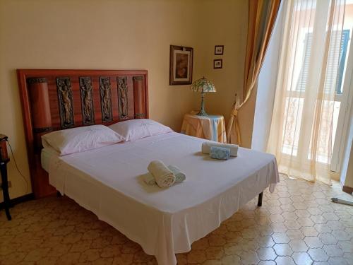 a bedroom with a bed with two towels on it at La Terrazza nel cuore di Capoliveri in Capoliveri