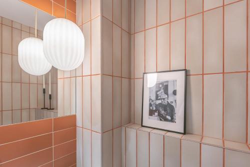 a room with two lights and a picture on a wall at Attic Oasis in Málaga