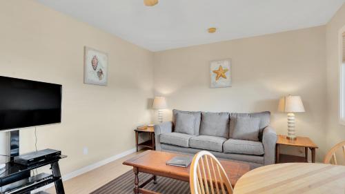 a living room with a couch and a table at Montauk Oceanside Suites in Montauk