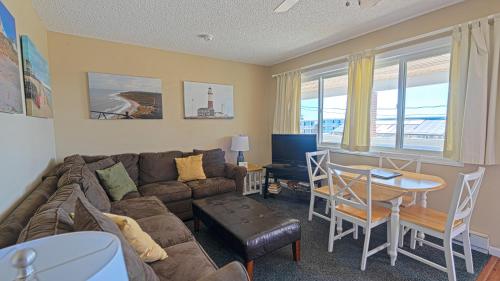 a living room with a couch and a table at Montauk Oceanside Suites in Montauk