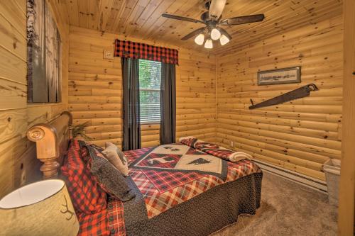 a bedroom with a bed in a log cabin at Updated Manistique Log Cabin, Yard and Fire Pit in Manistique
