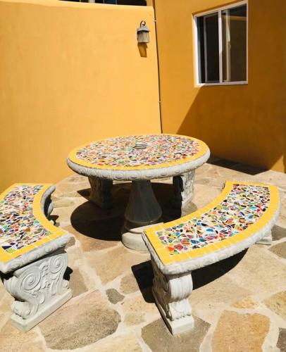a table and two benches with sprinkles on it at Adorable Casita w/Estuary & Ocean Views in Ensenada