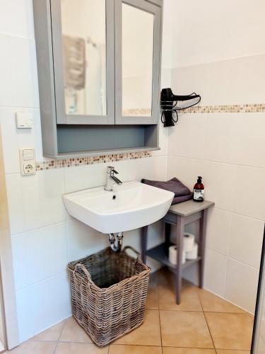 a bathroom with a sink and a mirror at Ferienwohnung Hornig Zwei Terrassen, Parkplatz, separater Eingang in Sulzfeld am Main