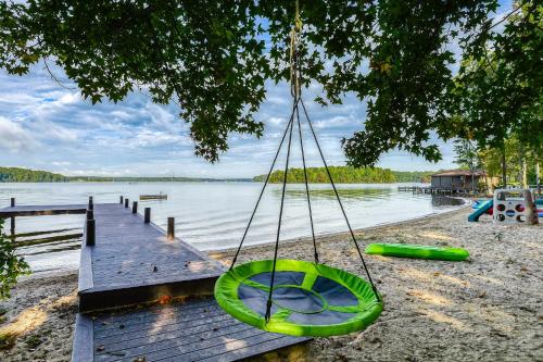 a swing hanging from a tree over a dock at Sunset Beach in Glenora
