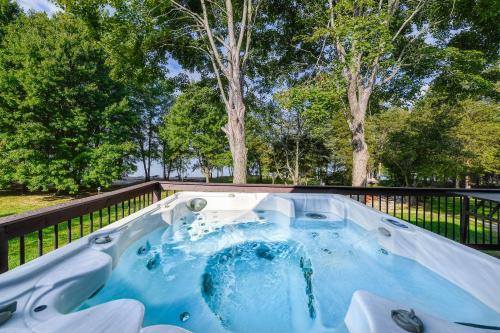 a hot tub in a backyard with trees in the background at Sunset Beach in Glenora