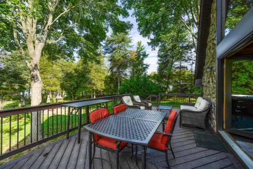 a patio with a table and chairs on a deck at Sunset Beach in Glenora