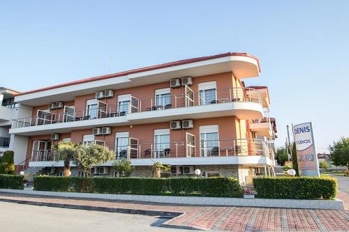 a building with balconies on the side of a street at Denis Studios and Apartments in Paralia Katerinis