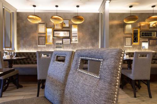 a restaurant with chairs and a table in a room at Schull Harbour Hotel & Leisure Centre in Schull
