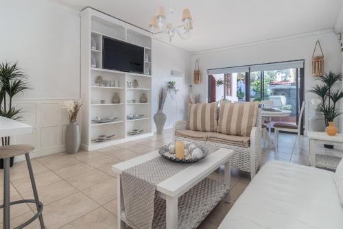 a living room with a couch and a table at Anoud Manor in Hout Bay