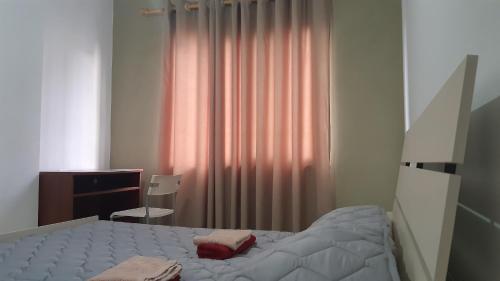 a bedroom with a bed and a desk and a window at Home Sweet Home 3 - Guest House in Tirana