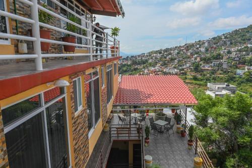 a balcony of a building with a view of a city at Casa LEONOR in Oaxaca City