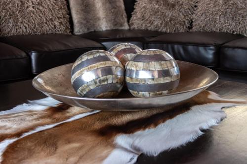 two wooden eggs in a bowl on a table at Anoud Manor in Hout Bay
